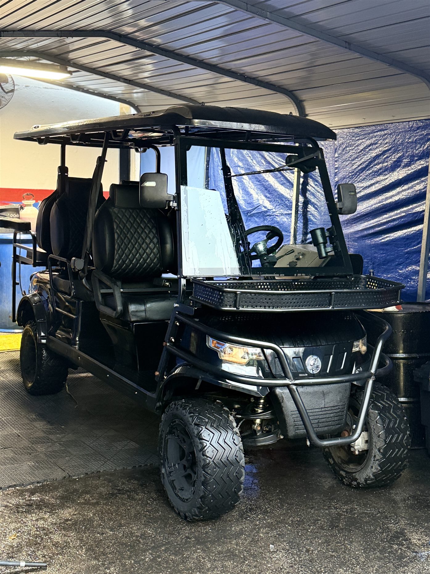 Golf cart or utility vehicle being serviced by Pulgar Motors.