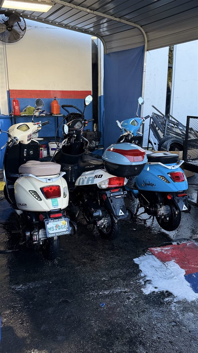 Multiple scooters outside the Pulgar Motors location.