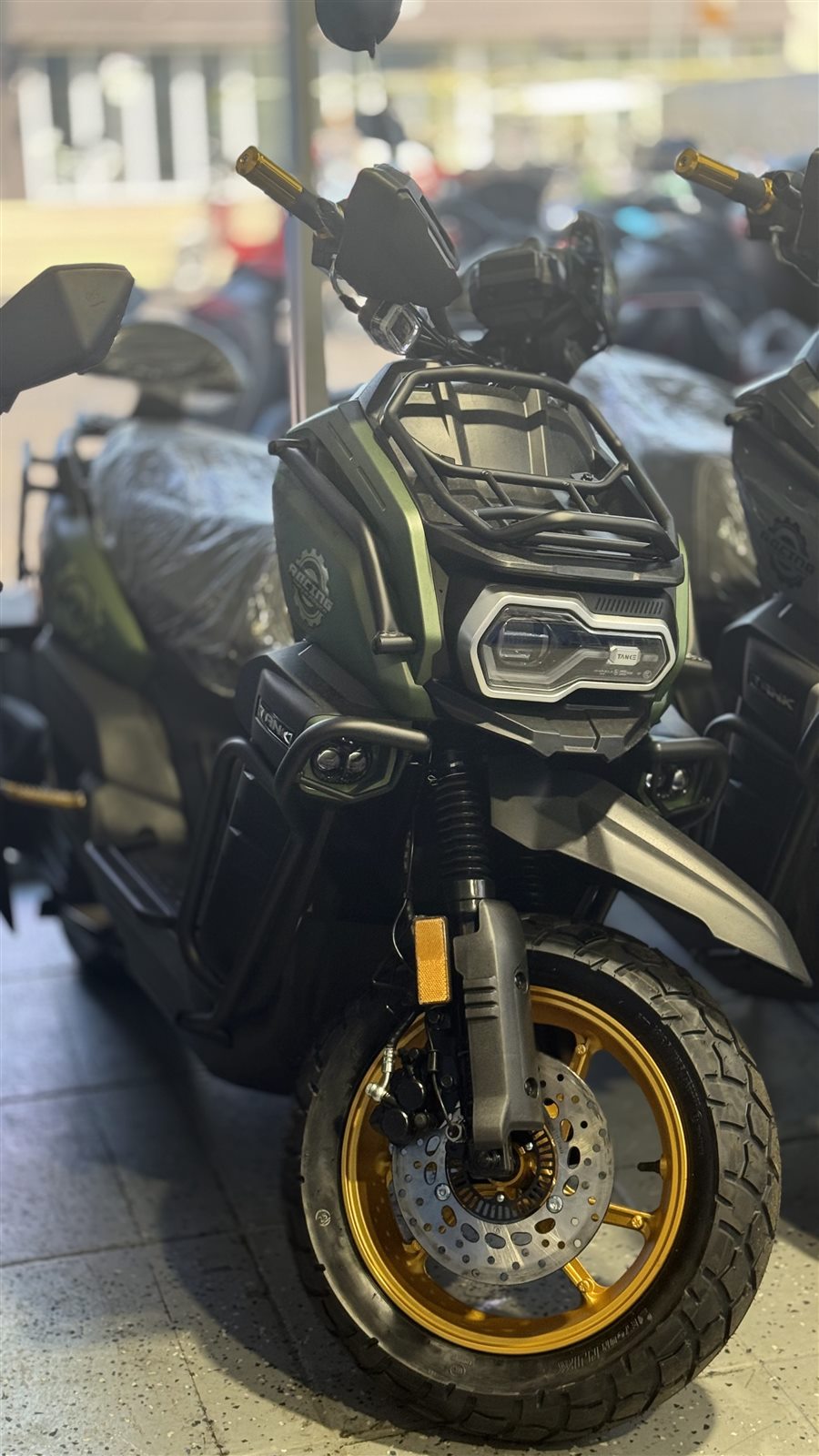 Black scooter positioned inside the Pulgar Motors showroom.