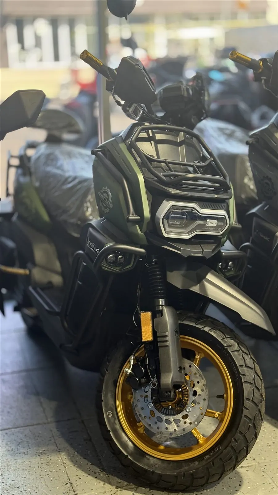 Black scooter positioned inside the Pulgar Motors showroom in Miami.